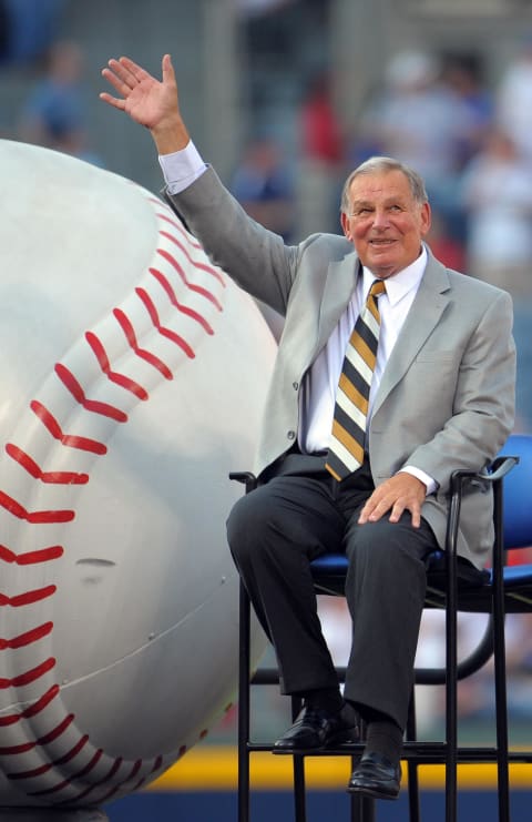 Former Atlanta Braves manager Bobby Cox waves to the crowd prior to the retirement of his number.