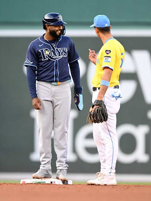 Sep 28, 2024; Boston, Massachusetts, USA; Tampa Bay Rays shortstop Junior Caminero (13) talks with Boston Red Sox second baseman Vaughn Grissom (5) during the fourth inning at Fenway Park. Mandatory Credit: Brian Fluharty-Imagn Images