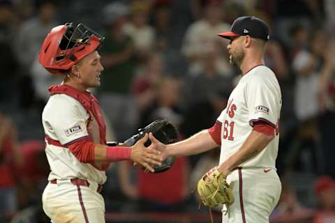 Jul 30, 2024; Anaheim, California, USA; Los Angeles Angels catcher Matt Thaiss (21) congratulates relief pitcher Hunter Strickland (61) after a save in the ninth inning against the Colorado Rockies at Angel Stadium. Mandatory Credit: Jayne Kamin-Oncea-Imagn Images