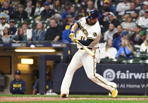 Sep 27, 2023; Milwaukee, Wisconsin, USA; Milwaukee Brewers first baseman Rowdy Tellez (11) hits a double against the St. Louis Cardinals in the fourth inning at American Family Field. Mandatory Credit: Michael McLoone-Imagn Images