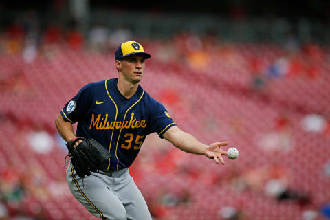 Milwaukee Brewers relief pitcher Brent Suter (35) plays a ground ball off the bat of a Cincinnati Reds player.