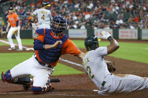 Oakland Athletics center fielder Starling Marte (2) is safe at after a tag was applied by Jason Castro.