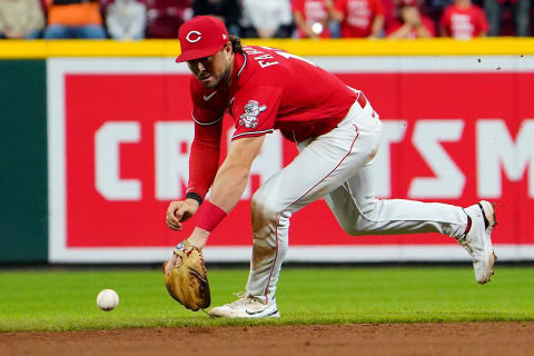 Cincinnati Reds shortstop Kyle Farmer (17) is unable to reach a ground ball hit.