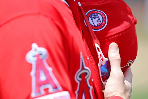 Los Angeles Angels players wear hats commemorating Memorial Day.