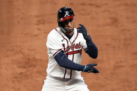 Atlanta Braves left fielder Eddie Rosario (8) reacts after a hit.