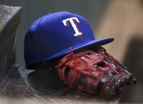 A view of the cap and glove of Texas Rangers.
