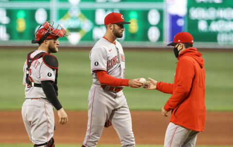 Cincinnati Reds relief pitcher Ryan Hendrix (C) hands the ball to David Bell.