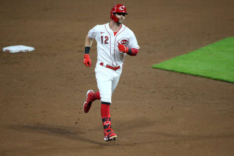 Cincinnati Reds center fielder Tyler Naquin (12) rounds the bases after hitting a home run.