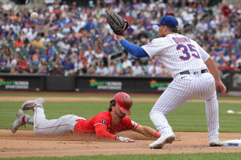 Cincinnati Reds shortstop Kyle Farmer (17) slides into third base ahead of tag from Brandon Drury.