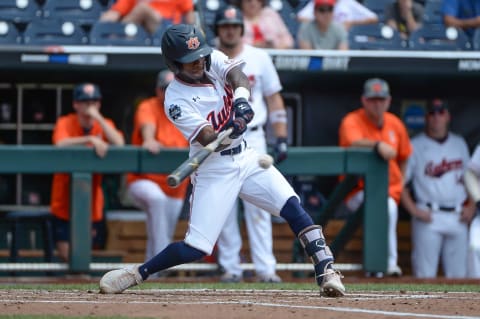 Jun 19, 2019; Omaha, NE, USA; Auburn Tigers second baseman Ryan Bliss (9) singles in the seventh  and current Diamondbacks 2B prospect