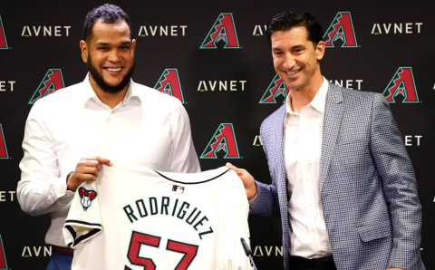 Arizona Diamondbacks starting pitcher Eduardo Rodriguez holds up his jersey with GM Mike Hazen