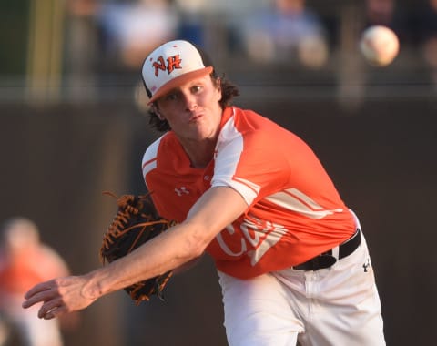 New Hanover pitcher Blake Walston throws against D.H. Conley in game one of the East Regional Final