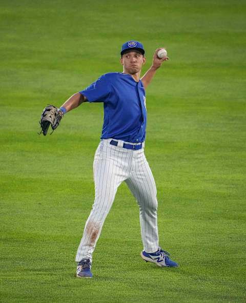 Iowa Cubs center fielder Darius Hill throws the ball infield after making a catch for an out against