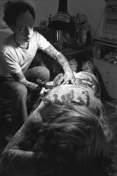 JOHN WYATT, “THOM DE VITA AND CLIENT IN HIS STUDIO AT 326 E 4TH STREET,” 1976, GELATIN SILVER PRINT COURTESY OF THE ARTIST