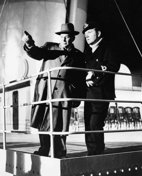 Actor Kenneth More (right) as Second Officer Charles Lightoller speaks with 'Titanic' survivor Gus Cohen on the set of 'A Night to Remember.'