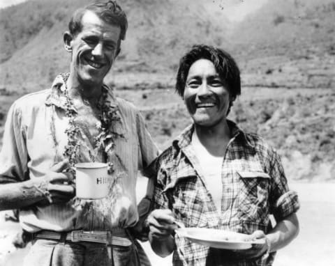 Edmund Hillary (left) and Tenzing Norgay enjoy a snack on their return from the summit of Mount Everest.