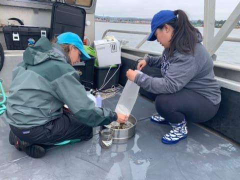 Shirel Kahane-Rapport (left) and Lauren Kashiwabara collect microplastics from whale feeding grounds in Monterey Bay, California.