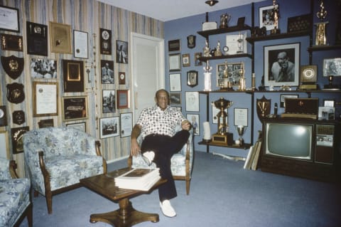 Jesse Owens at home in Phoenix, Arizona, surround by his winning trophies.