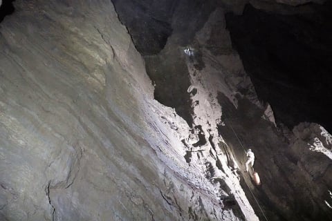 Caver Pavel Demidov climbing in Veryovkina Cave.