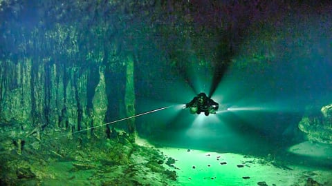 A diver swims through the Ox Bel Ha cave system.