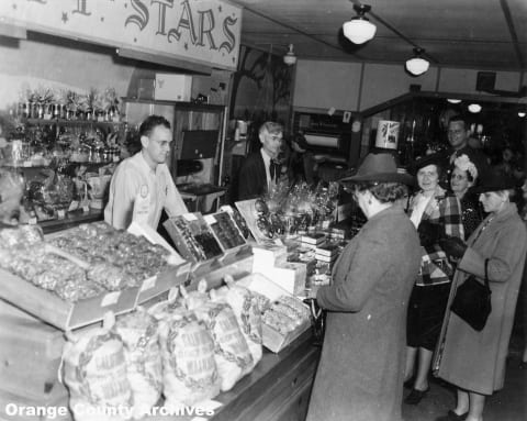 Walter Knott and his son, Russell, working at the Berry Market.