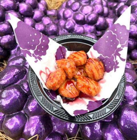 Knott’s Boysenberry Festival Corn Fritters drizzled with boysenberry sauce.