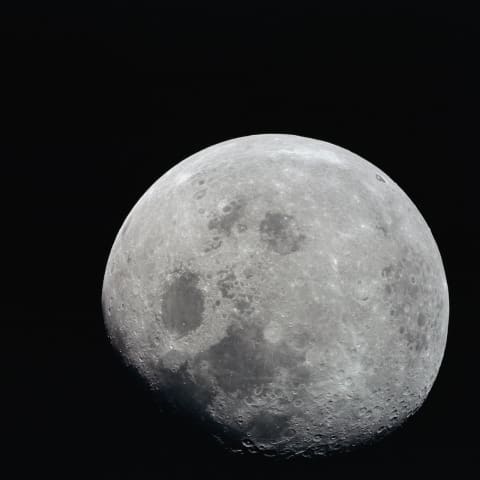 This photograph of a nearly full moon was taken from the Apollo 8 spacecraft at a point above 70° east longitude in 1968.