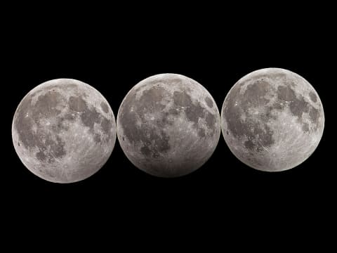 Time lapse image of a penumbral lunar eclipse. The center moon is at maximum eclipse, with 90 percent immersed in Earth's penumbra.