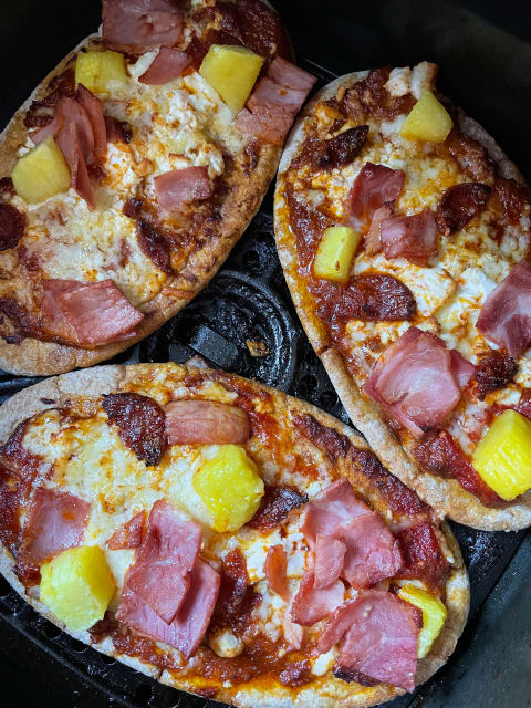 Your air fryer will heat your day-old pizza in no time.