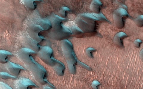 Frosted sand dunes far north of the Martian equator. The dunes' shapes help scientists understand more about the composition of the planet. 