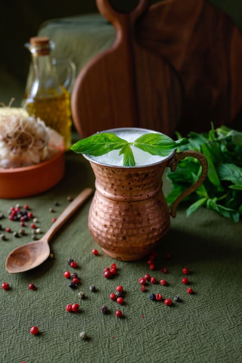 A refreshing mug of buttermilk with fresh mint.