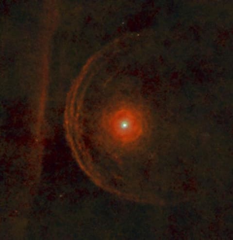 Betelgeuse, a red supergiant star, is surrounded by an envelope of clumpy material in this view from the Herschel Space Observatory.