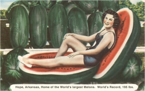 Vintage illustration of a woman lounging on two halves of a giant watermelon.