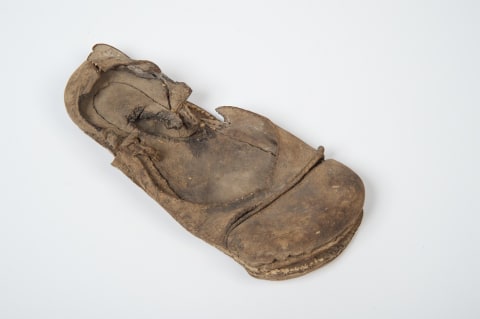 A Tudor leather bar strap shoe with a wide toe, circa 1530, found concealed above the ceiling of the dining room of St. John's College, Oxford.