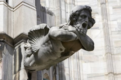 A stone gargoyle on the Duomo di Milano in Milan, Italy.