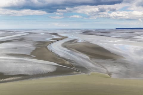 The tidal flats around Mont St. Michel, France, are prone to quicksand formation.