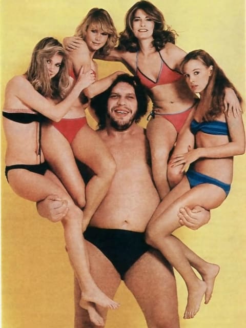 André the Giant holding four women.