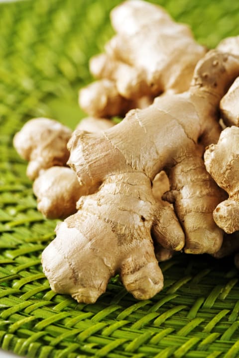 Fresh ginger on a green mat.