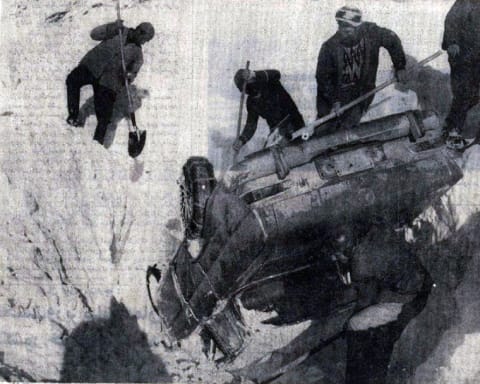 People attempt to free a crashed vehicle from a snowbank after the Ardakan blizzard.