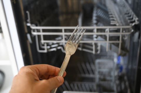 Loading forks with their pointy parts up is considered the optimal way to clean them in a dishwasher.