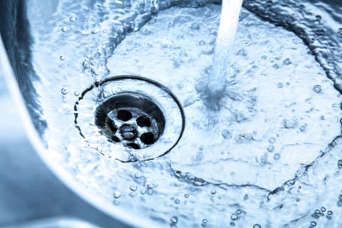 Water slides right off the metal surface of a sink.