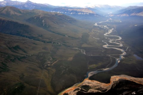 An aerial view of the Kutuk River in Alaska’s Gates of the Arctic National Park, where a portion of the water is rust-stained.