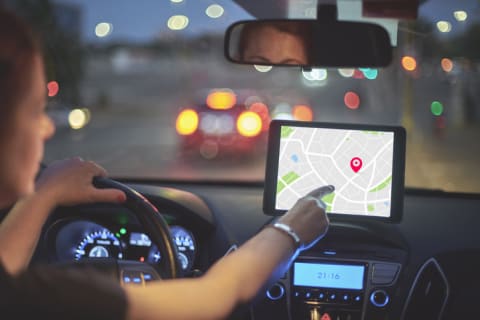 A woman using GPS in her car.