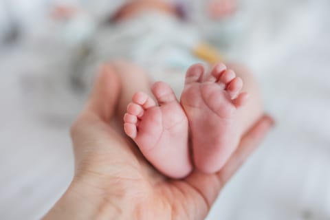 The soles of a baby’s feet.