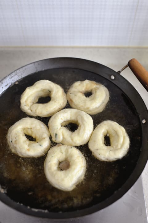 Bagels being boiled.