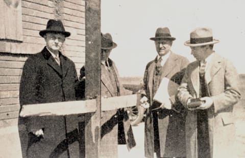 Engineers examine a 1-inch-by-5-inch board driven through a 2-inch-by-6-inch plank by the Tri-State Tornado.