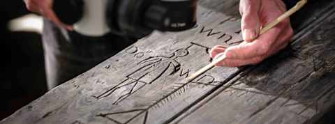 A hanged man etched into a door in Dover Castle.