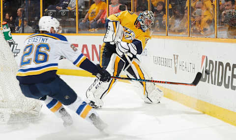 NASHVILLE, TN – FEBRUARY 25: Pekka Rinne #35 of the Nashville Predators clears the puck behind the net against Paul Stastny #26 of the St. Louis Blues during an NHL game at Bridgestone Arena on February 25, 2018 in Nashville, Tennessee. (Photo by John Russell/NHLI via Getty Images)