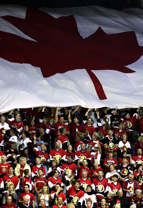 OTTAWA, ON – JUNE 04: Ottawa Senator fans hold a Canadian flag during the National Anthem prior to the start of Game Four of the 2007 Stanley Cup finals between the Anaheim Ducks and the Ottawa Senators on June 4, 2007 at Scotiabank Place in Ottawa, Canada. (Photo by Jeff Gross/Getty Images)