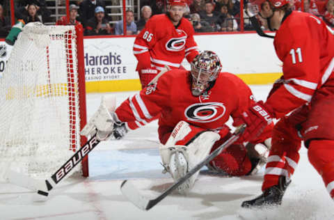 RALEIGH, NC – DECEMBER 23: Justin Peters #35 of the Carolina Hurricanes reaches out to control the puck during an NHL game against the Columbus Blue Jackets at PNC Arena on December 23, 2013 in Raleigh, North Carolina. (Photo by Gregg Forwerck/NHLI via Getty Images)